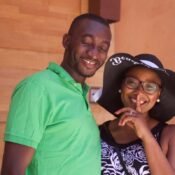 Close up portrait of young smiling African couple standing outside