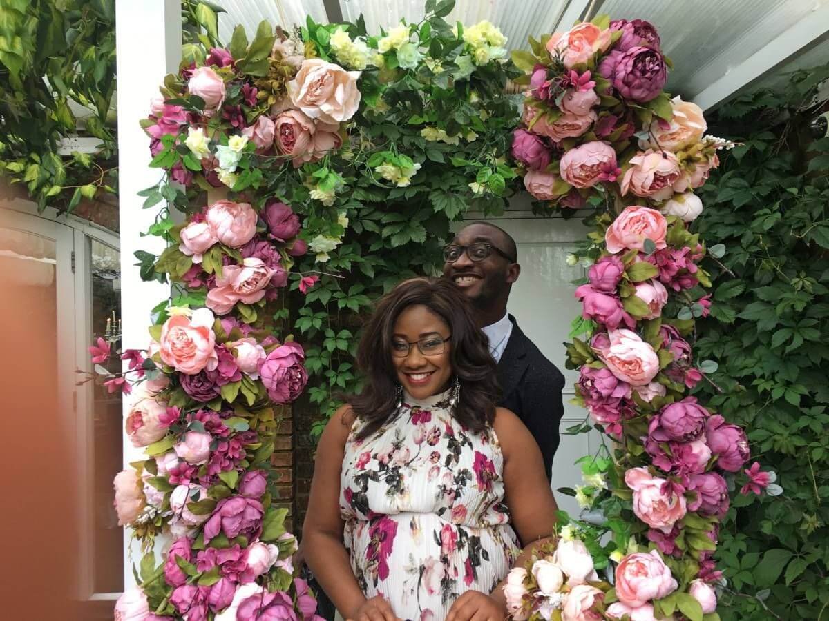 Image of ao young african couple at a wedding posing for the camera. Tolulope Olajde and Chidinma Onuzo