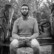 Tolulope Olajide with his eyes closed gets drenched by a heavy rain as he sits on a bench in the woodlands. Loss of Spouse; Being Widowed and Young